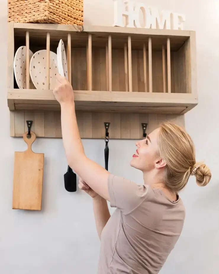 Woman taking plate from shelf 23 2148341738